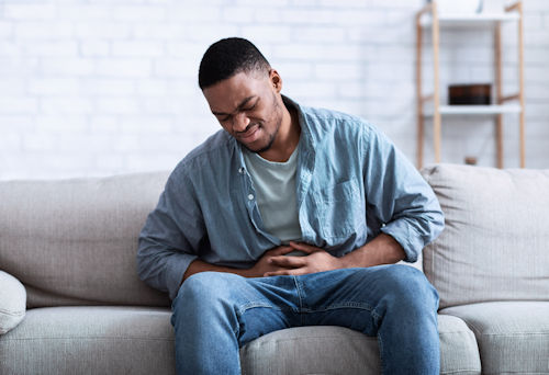 black-guy-having-painful-stomachache-touching-aching-stomach.jpg