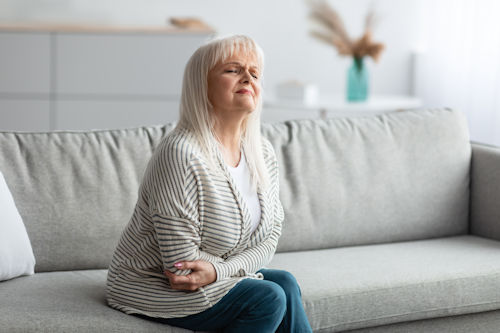 mature-woman-suffering-from-stomachache-touching-stomach.jpg